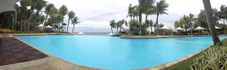 Palm-lined infinity pool at Shangri-La Mactan overlooking the sea