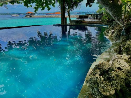 Pool beside the shore shown in the supplied Chema's by the Sea property photo